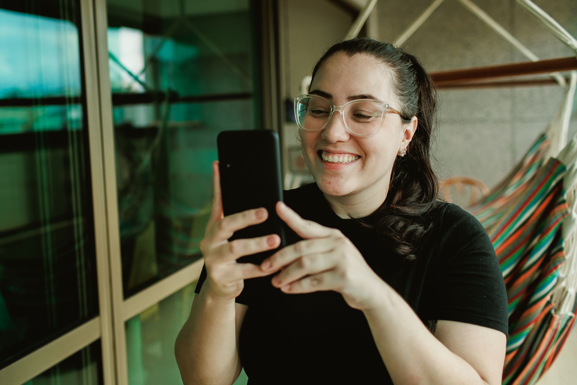 Woman smiling while taking a which ___ are you quiz on her phone