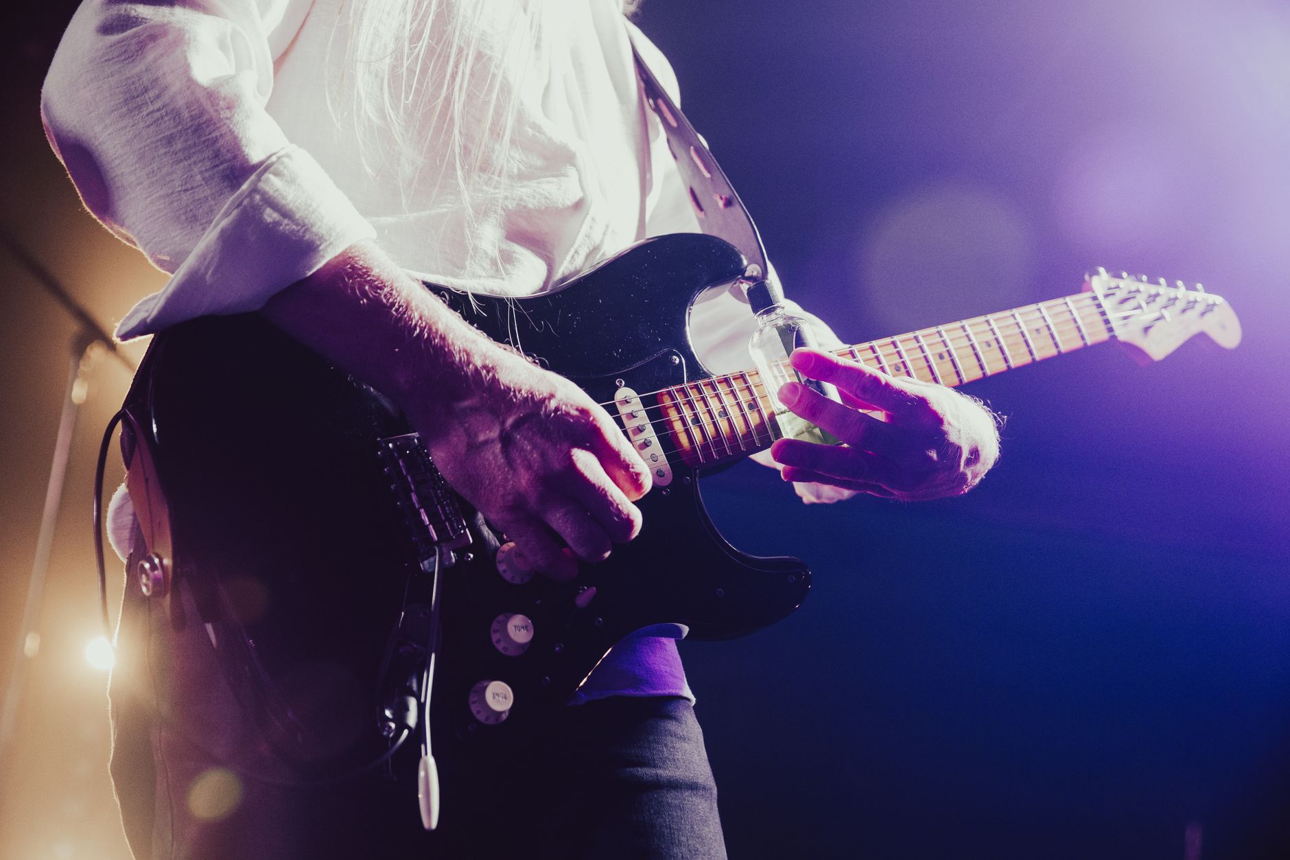 Retro rock concert stage with guitar and colored lights