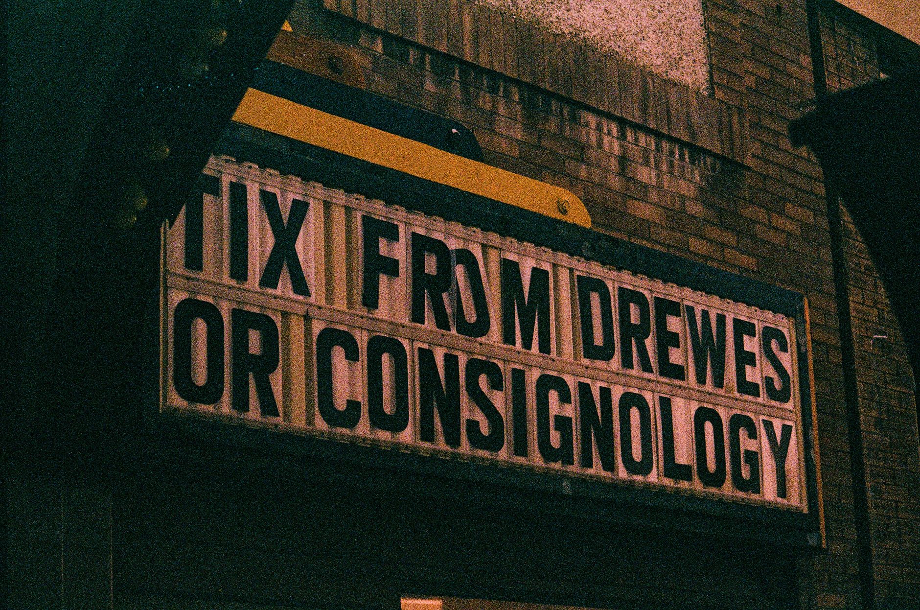 Retro movie theater marquee lit up at night