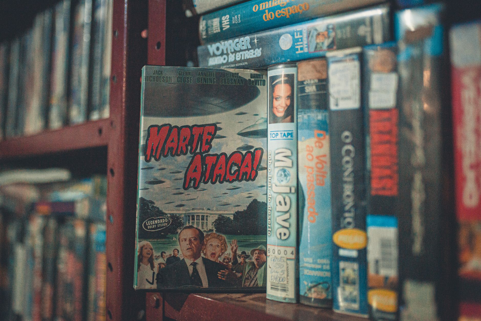 Rows of VHS tapes on a video store shelf