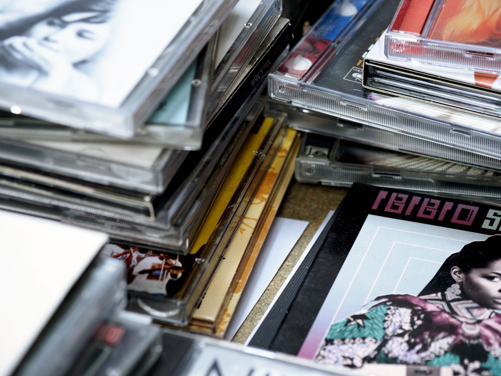 Stack of CD jewel cases from the 90s music era