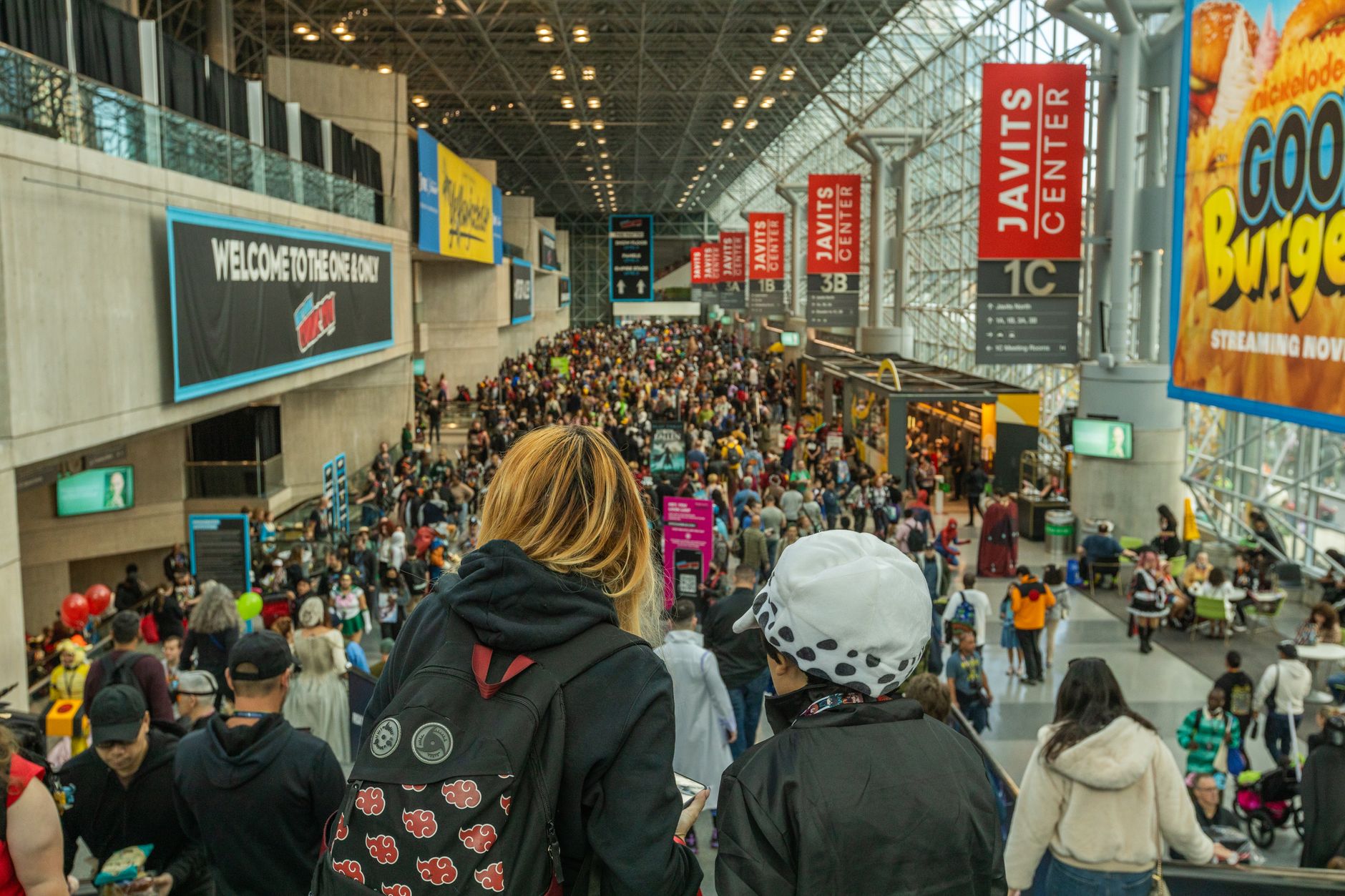 Crowd of fans in cosplay costumes at a convention