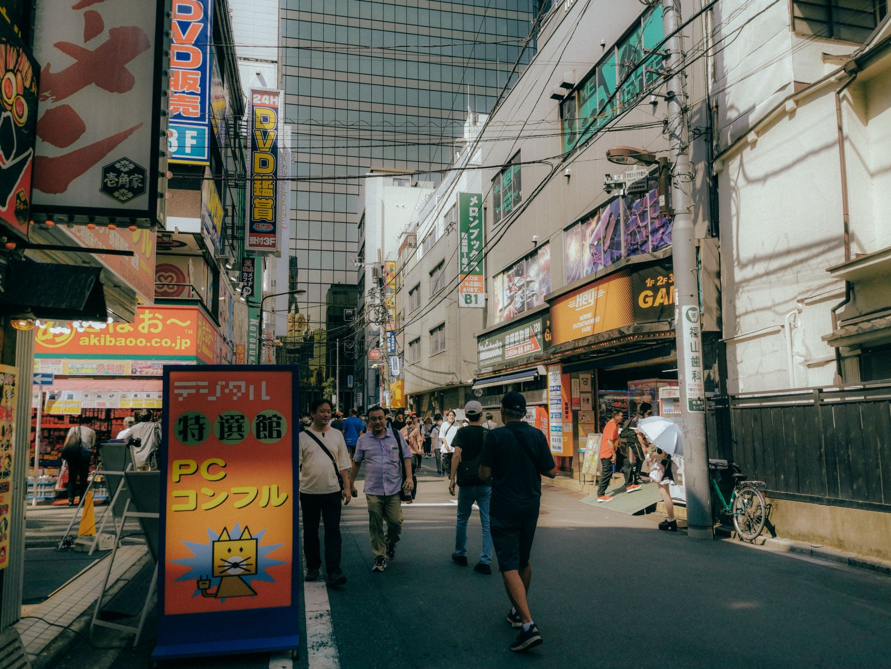 Neon signs lighting up a Tokyo shopping street at night