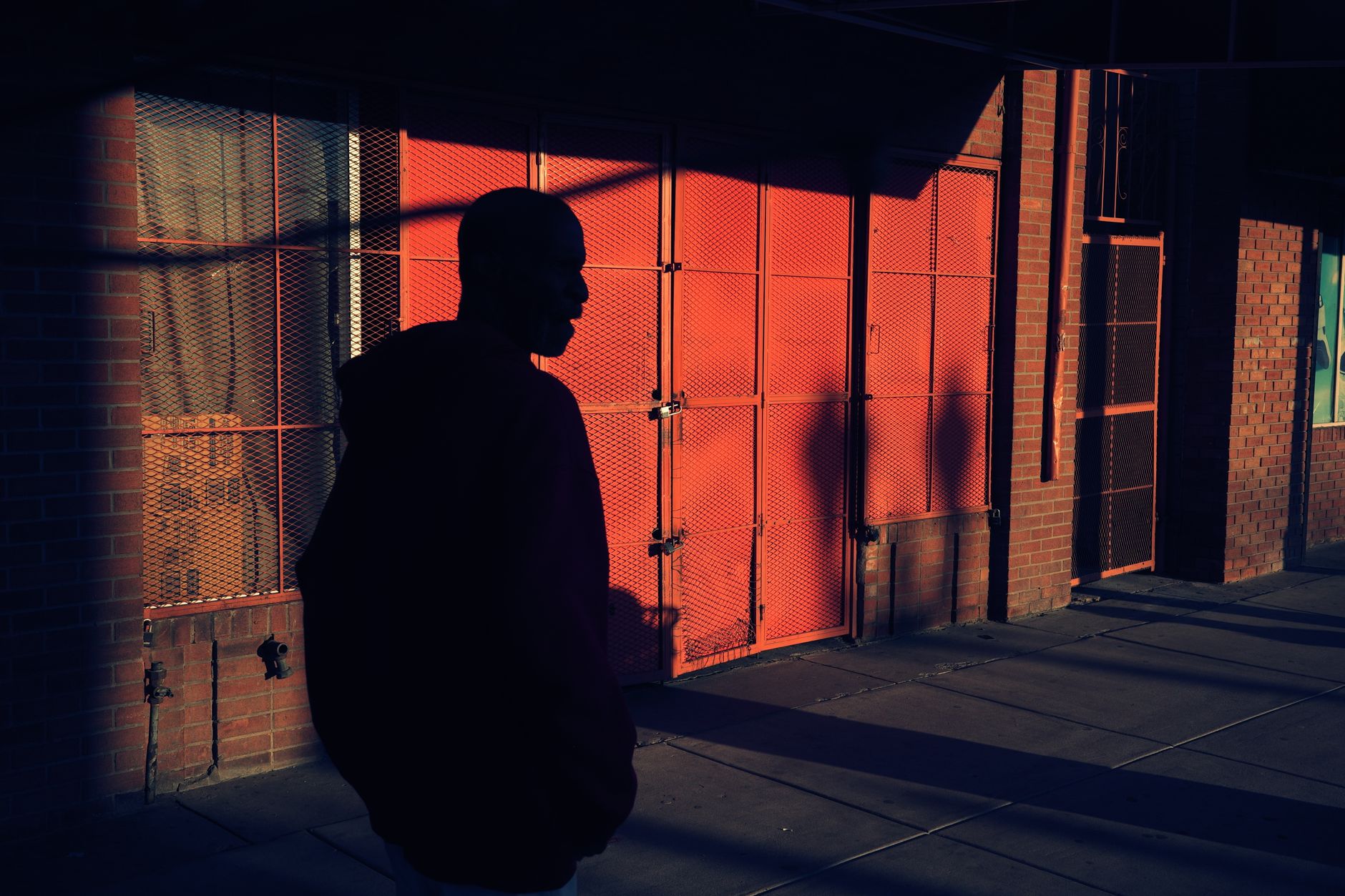 Dramatic shadow of a silhouetted figure against a wall
