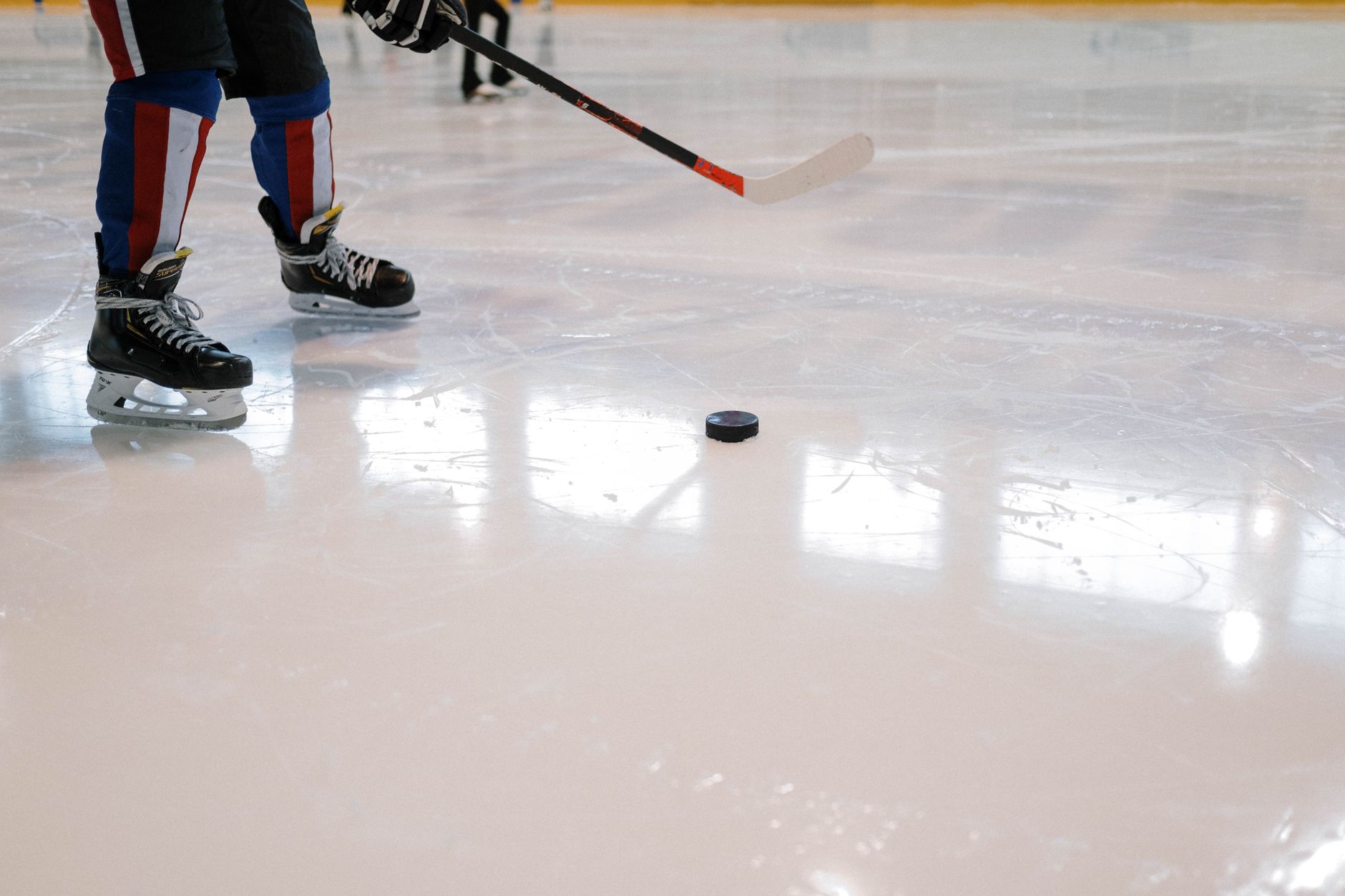 Hockey stick and puck resting on the ice