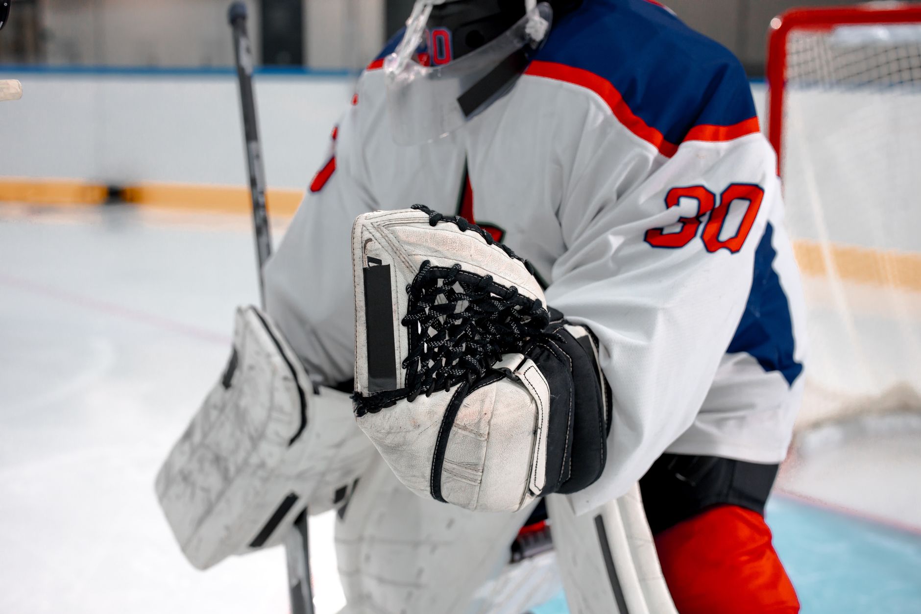 Hockey goalie making a save in front of the net