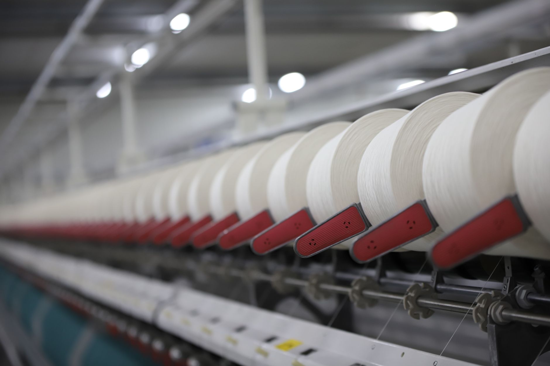 Rows of spinning and weaving machines inside a 19th century textile mill