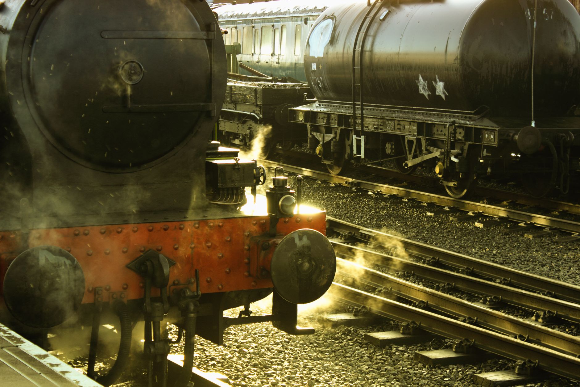 Vintage steam locomotive train on railway tracks