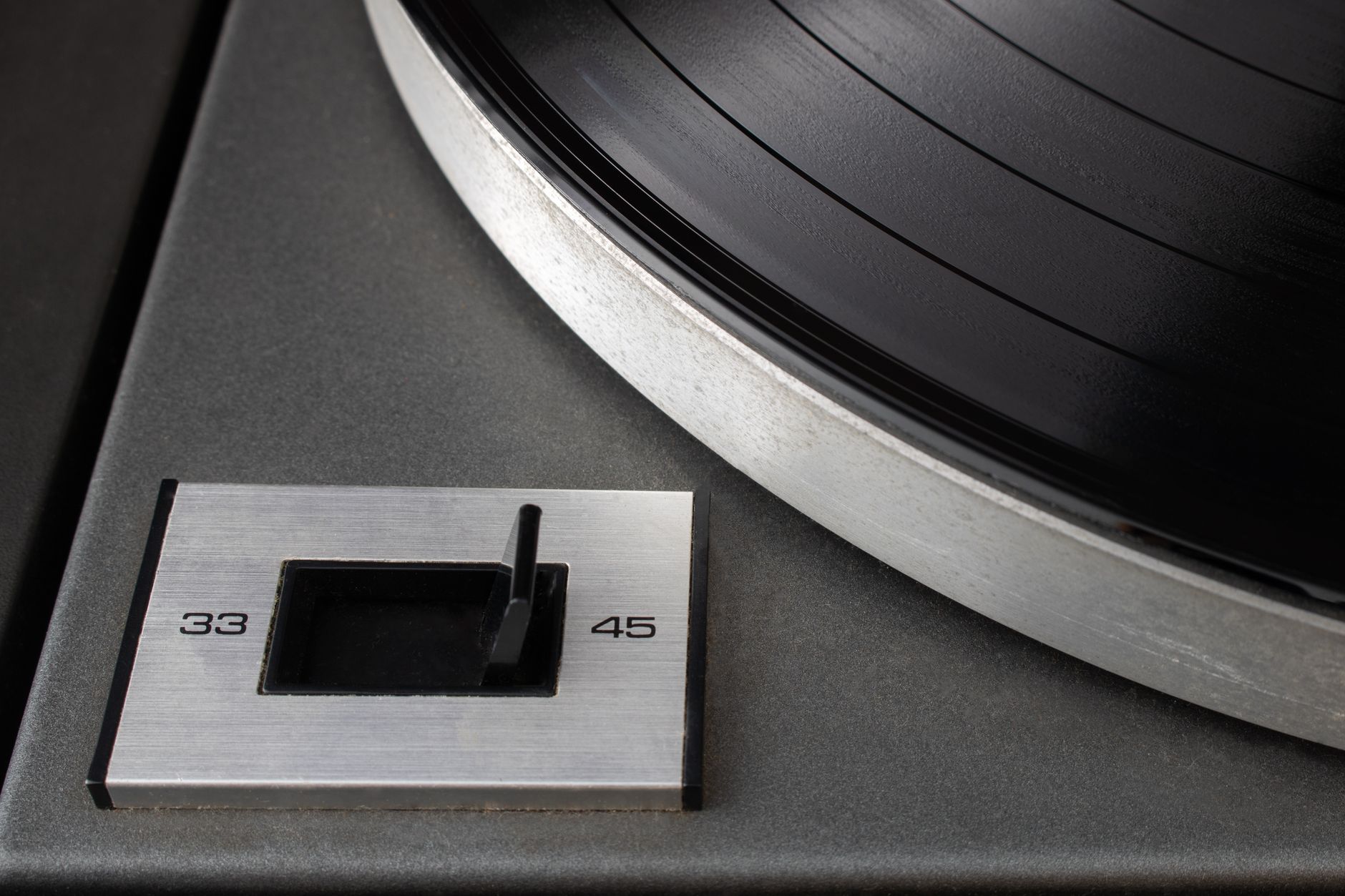Vinyl record player closeup with needle on spinning record