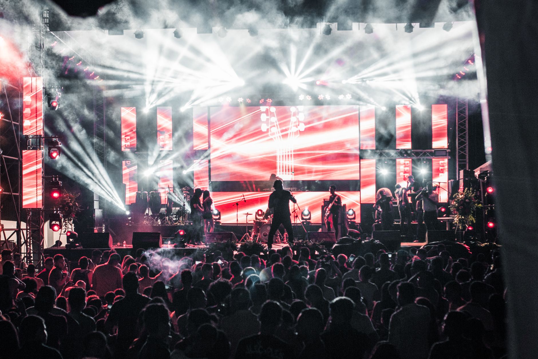 Crowd at a live music festival concert with stage lights