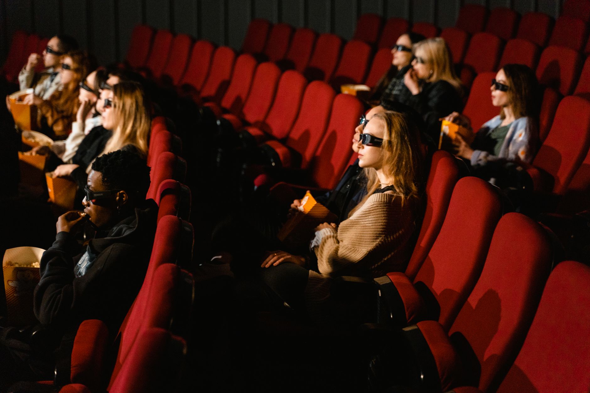 Movie theater with red velvet seats and big screen ready for a film