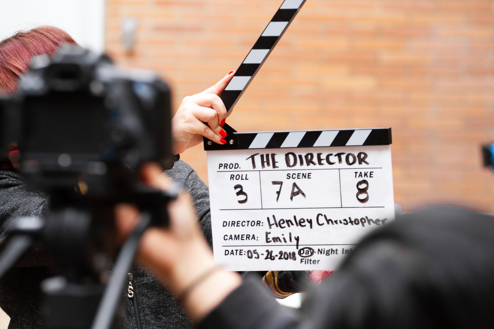 Film director looking through camera on a movie production set