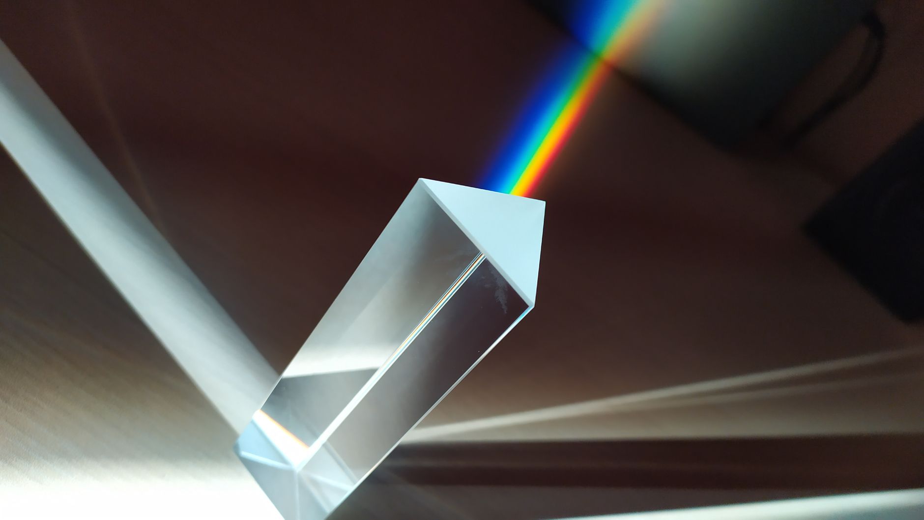 Light beam splitting into colors through a glass prism