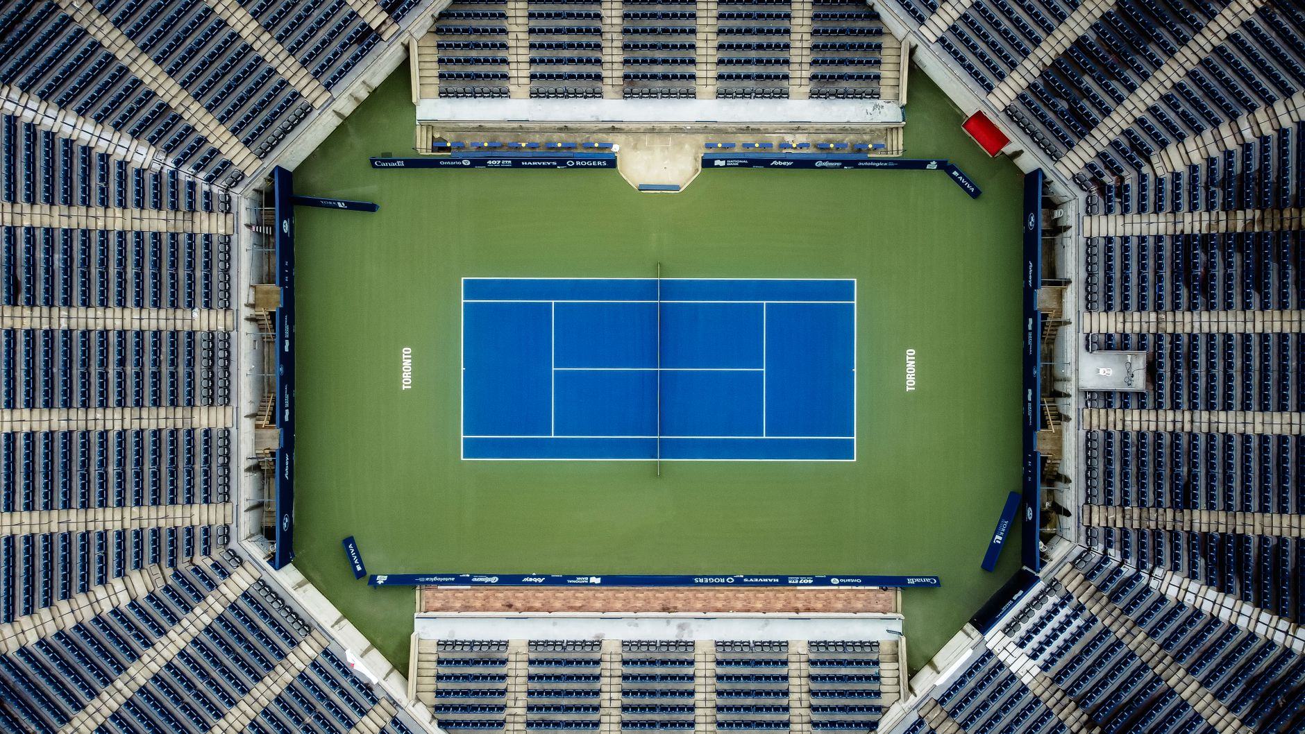 Tennis player serving on a grass court at a Grand Slam championship