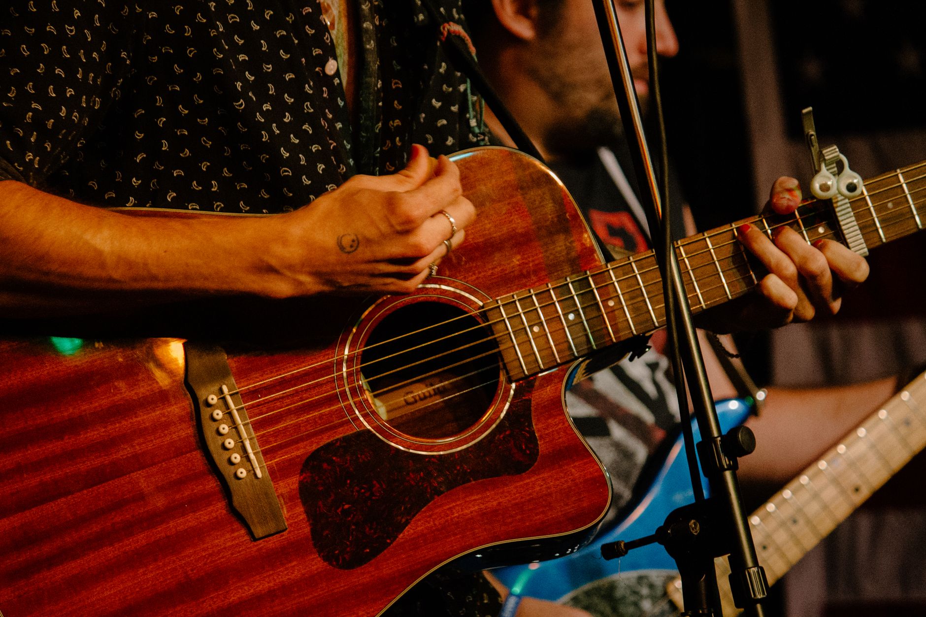 Acoustic guitar resting on a stage before a concert