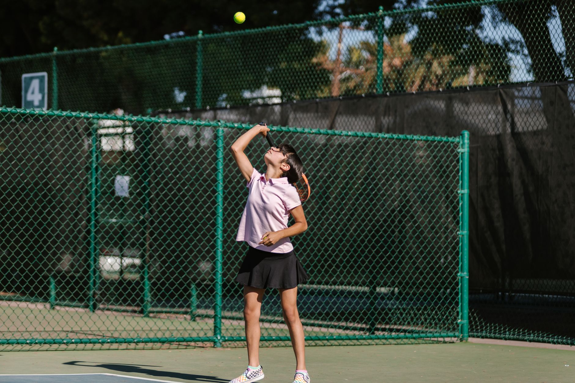 Tennis player serving on a grass court