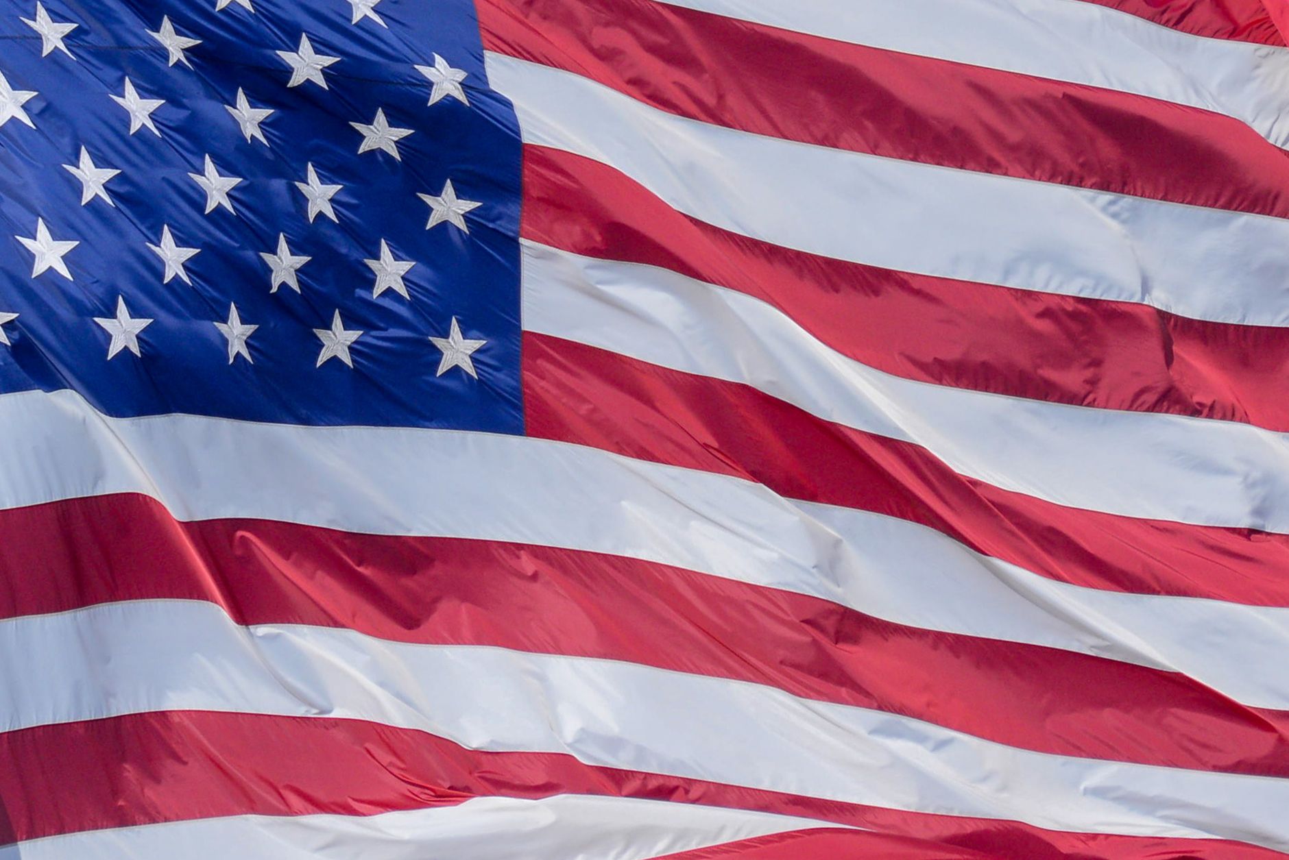 American flag waving against a blue sky