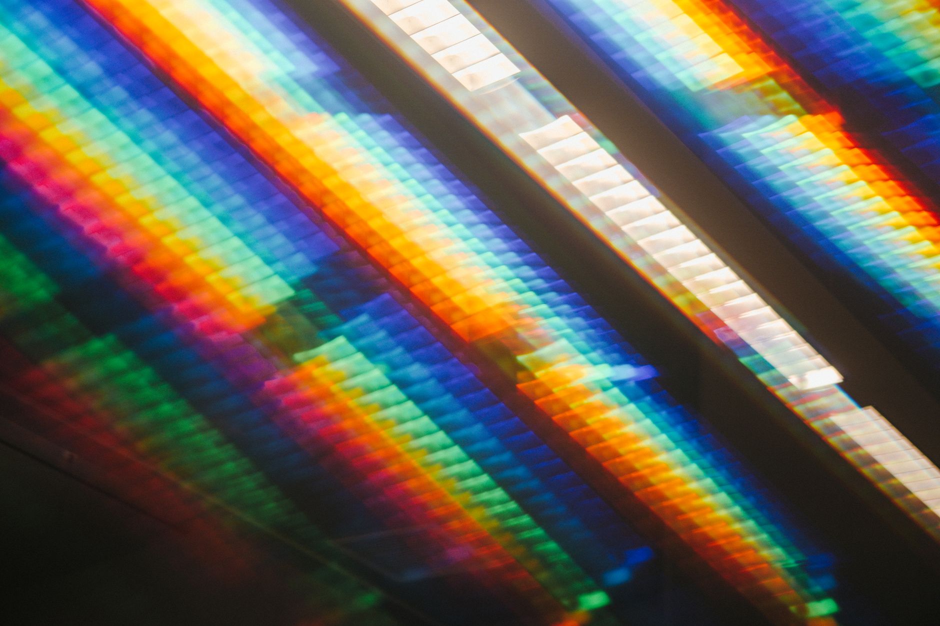Abstract rainbow-colored light streaks representing the spectrum of aura colors