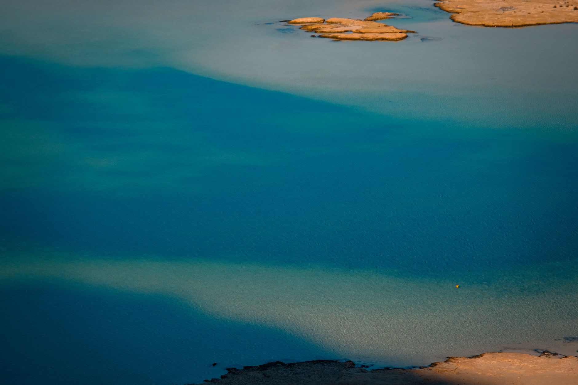 Calm blue lake reflecting the sky, representing the intuitive calm of Water personalities